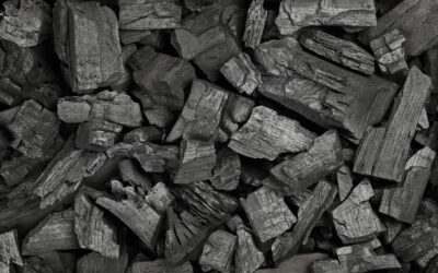 Close up background texture of many black lump charcoal pieces ready for barbecue grill, elevated top view, directly above